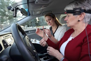 A University of Utah research assistant introduces a participant in new distracted driving studies to special devices designed to gauge mental distraction during road tests.