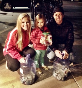 Taylor Dalebout and Brady Donaldson with a young Utah fan at Rice-Eccles Stadium collection day.