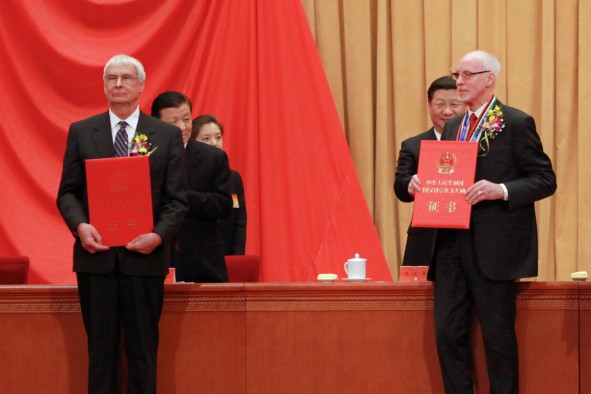 University of Utah chemist Peter J. Stang (left) and Swedish scientist Jan-Christer Janson on stage Jan. 8, 2016, in the Great Hall of the People in Beijing, as they accept China’s International Science and Technology Cooperation Award. They were among seven winners. Chinese President Xi Jinping stands behind Janson on the right, while standing behind Stang are Liu Yunshan, first-ranked Secretary of the Central Secretariat of the Communist Party of China, and a staff member.