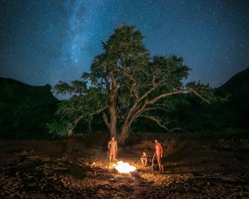 Ian McCluskey and his fellow river adventures enjoy an evening on the river during their filming trip.