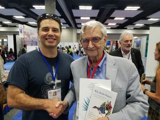 Çağan Şekercioğlu, left, presents a copy of “Why Birds Matter” to renowned conservationist E.O. Wilson at the IUCN World Conservation Congress. Wilson’s books inspired Şekercioğlu to study biology at Harvard University where Wilson is a professor.